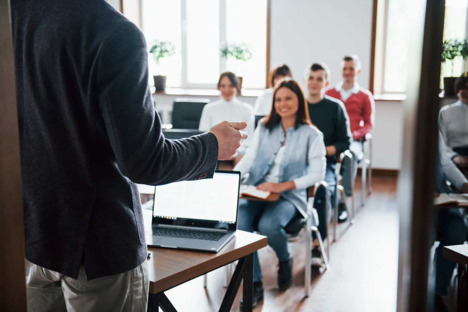 Instructor teaching a Lean Six Sigma training class to a seated group of learners